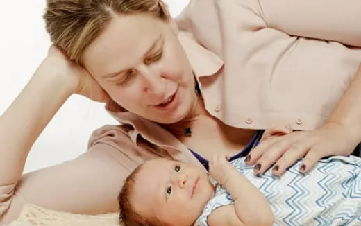 a woman holding a baby