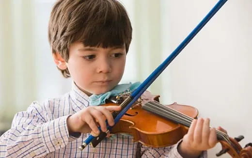a boy playing a violin