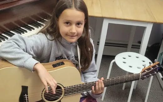 a girl playing a guitar