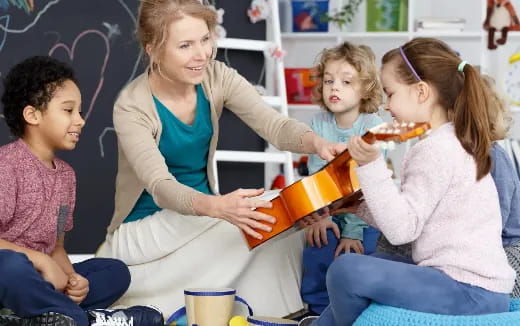a person reading a book to a group of children