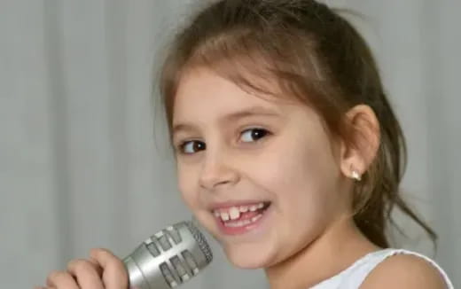a little girl holding a phone