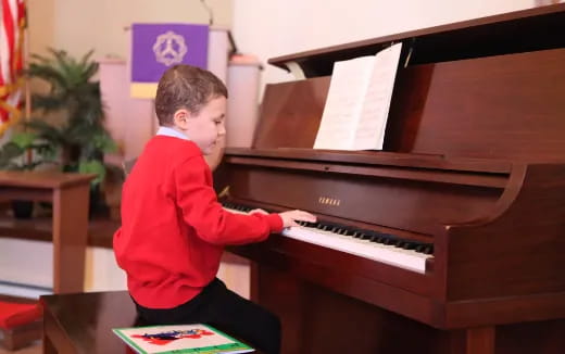 a boy playing a piano