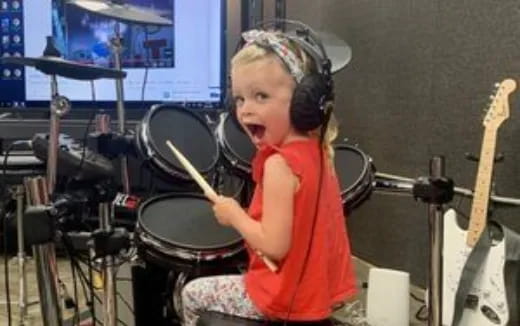 a girl playing the drums