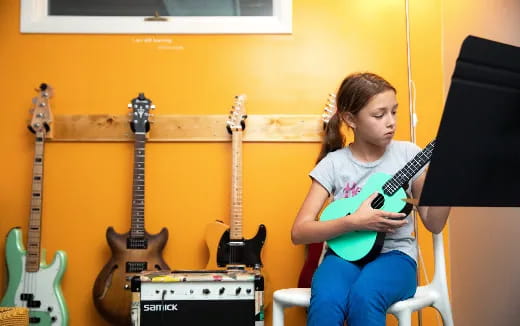 a girl playing a guitar