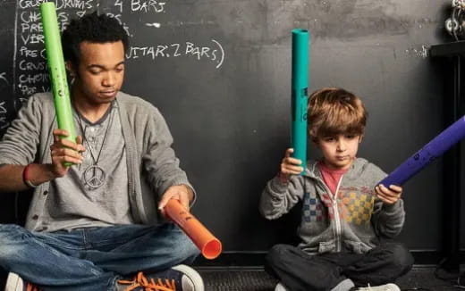 a person and a boy with baseball bats