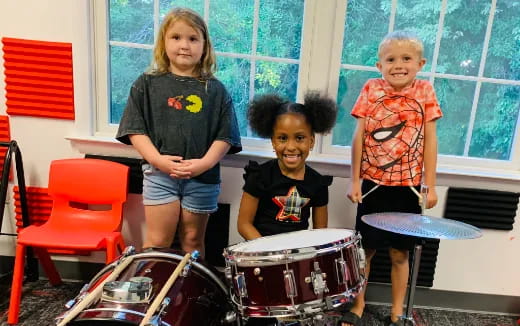 a group of kids playing drums