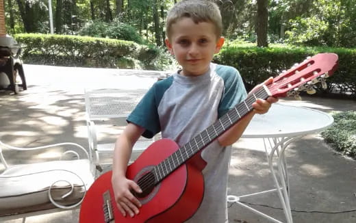 a boy playing a guitar