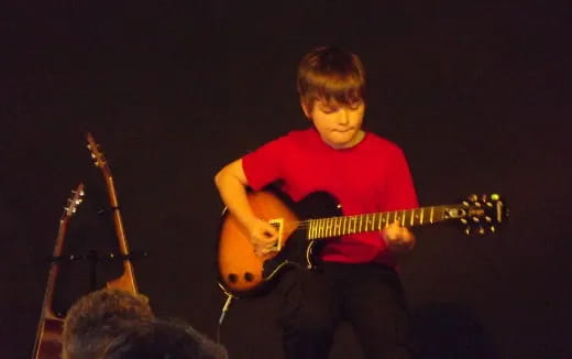 a man playing a guitar