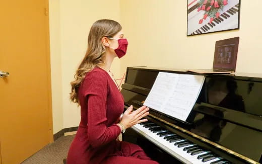 a woman playing a piano