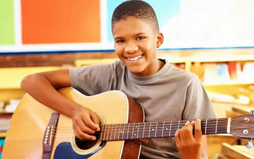 a boy playing a guitar