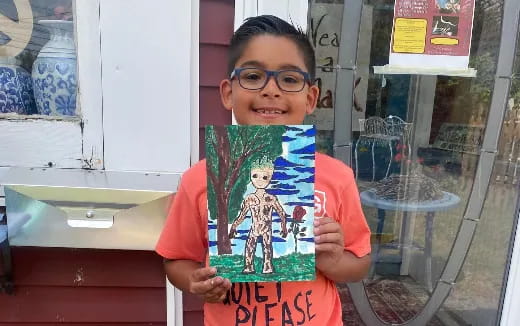 a boy holding a book