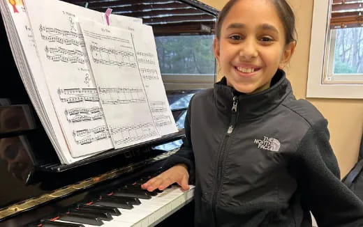a girl playing a piano
