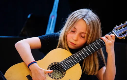 a woman playing a guitar