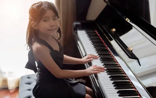 a girl playing a piano