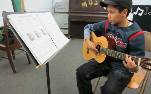 a boy playing a guitar