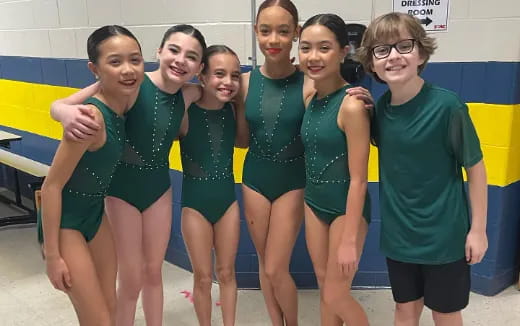 a group of women in swimsuits posing for a photo