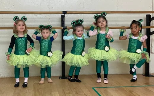 a group of girls in green dresses
