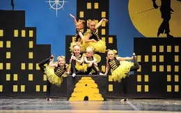 a group of children in clothing on a stage