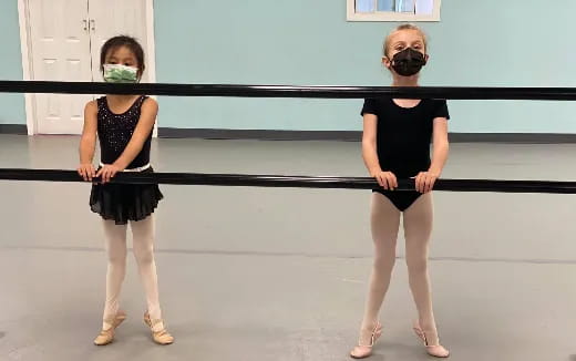 two women wearing masks