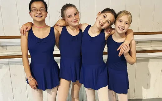 a group of girls in blue dresses