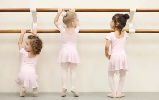 a group of girls in white dresses