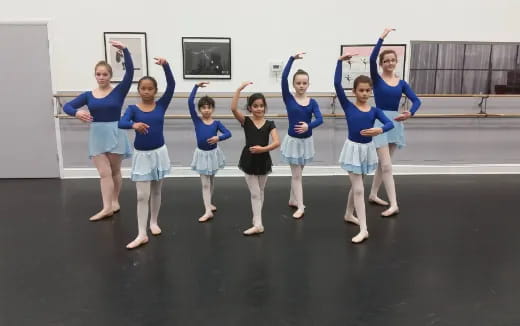 a group of girls in blue shirts