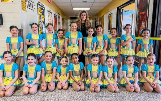 a group of girls in matching outfits