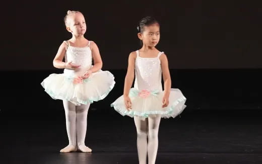 two girls wearing dresses