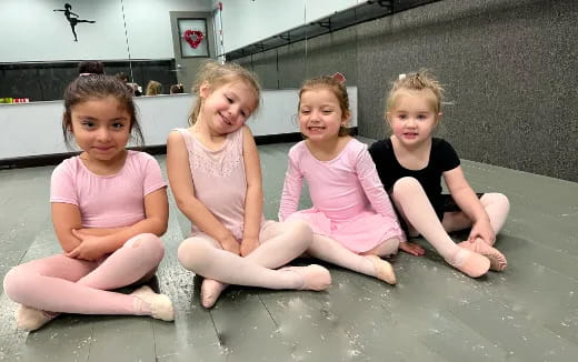 a group of girls sitting in a pool