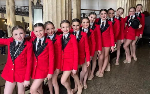 a group of girls in red and black uniforms