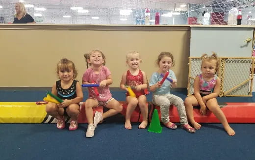 a group of children sitting on a bench
