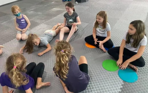 a group of children sitting on the ground