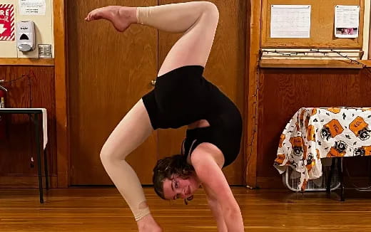 a woman doing a handstand