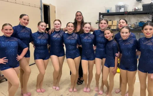 a group of girls in blue uniforms