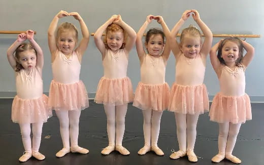 a group of girls in dresses