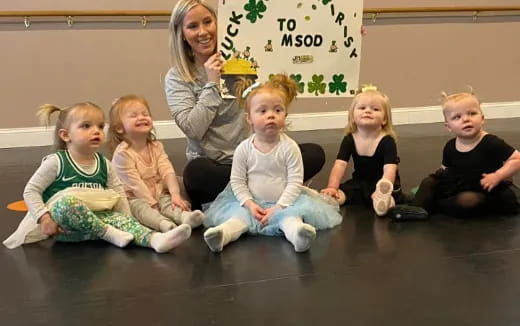 a group of children sitting on the floor