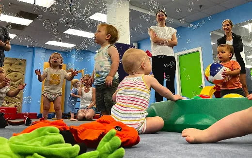 a group of children playing on a mat