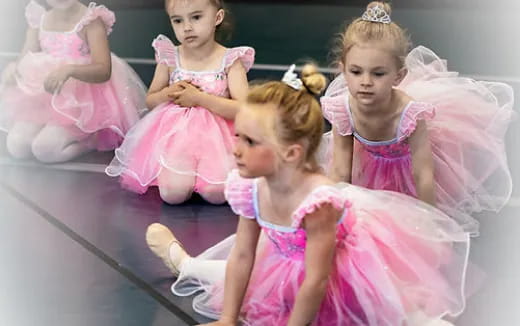 a group of girls in dresses