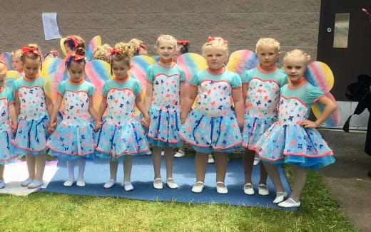 a group of girls in dresses