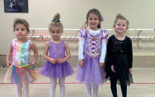 a group of girls in dresses