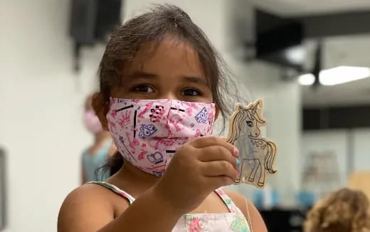 a girl holding a stuffed animal