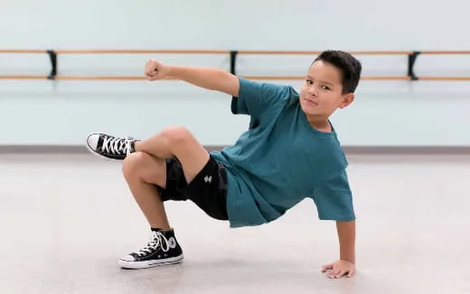 a boy kneeling on ice