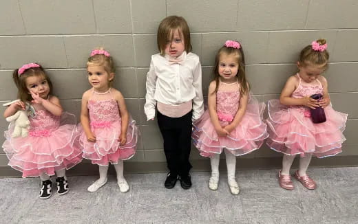 a group of girls in dresses