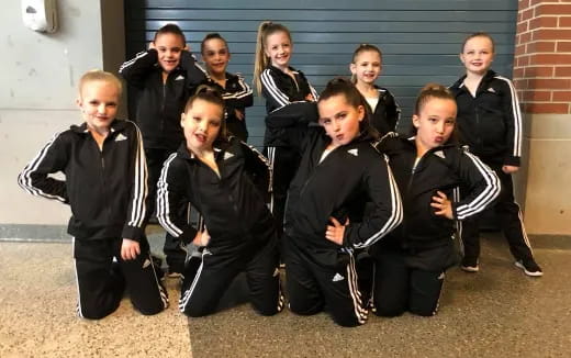 a group of children in black and white uniforms