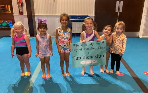 a group of girls holding a sign