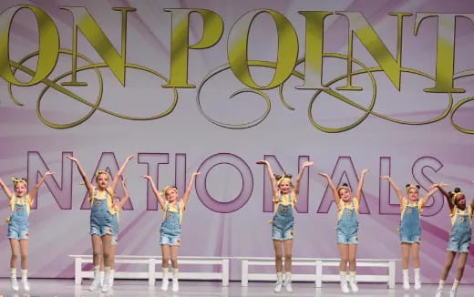 a group of women in blue dresses