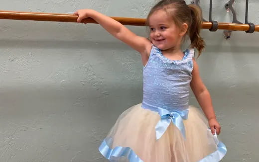 a girl in a dress on a swing