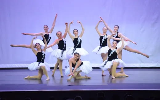 a group of women dancing on a stage
