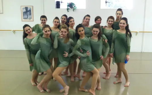 a group of women in green dresses