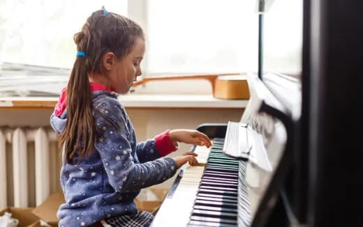 a young girl working on a computer